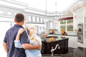 A man and woman stand in front of a kitchen, showcasing a drawing of a custom kitchen remodel in Tiburon, CA