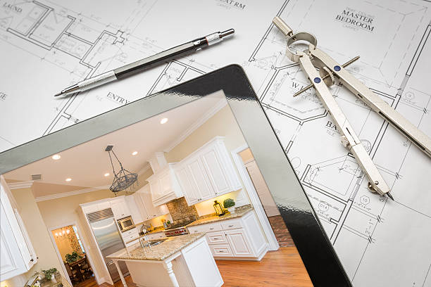 Computer tablet displaying a finished kitchen design, placed on house plans with a pencil and compass, representing professional general contractor services for home renovations in San Mateo.