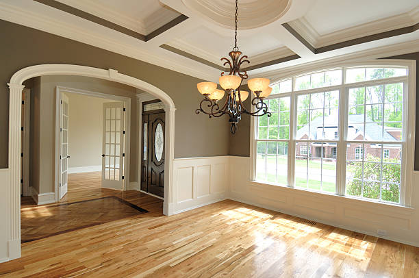 Spacious room with elegant hardwood floors and a stunning chandelier, part of a complete home remodeling in Burlingame.