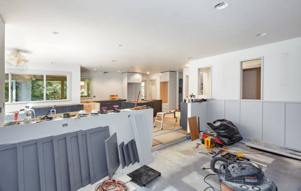 Painted cabinet doors, shelves, tools, lights, and trash bags decorate the kitchen and family room during an extensive Burlingame kitchen remodeling project.