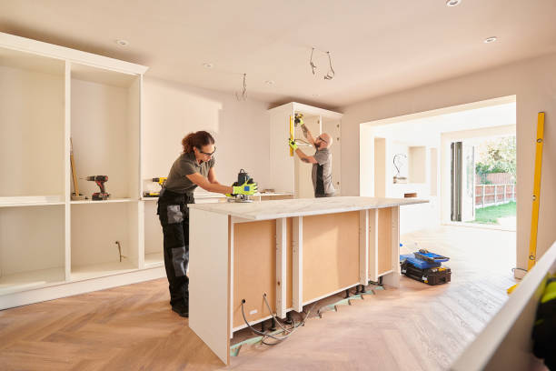 Two individuals collaborating in a Burlingame kitchen remodeling project, engaged in meal preparation and cooking activities.