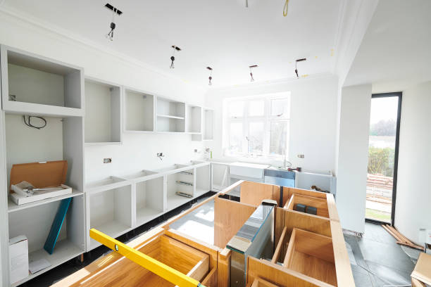 A modern kitchen remodeling project in progress, showcasing a partially finished design with sleek countertops and stylish cabinetry.