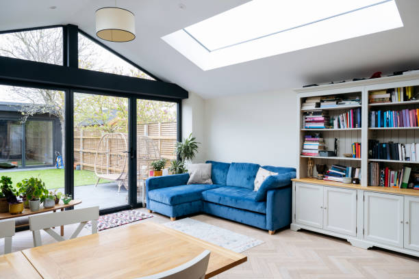 Open-plan living space in a modern home with patio doors leading to a beautifully designed garden, enhancing natural light and flow.