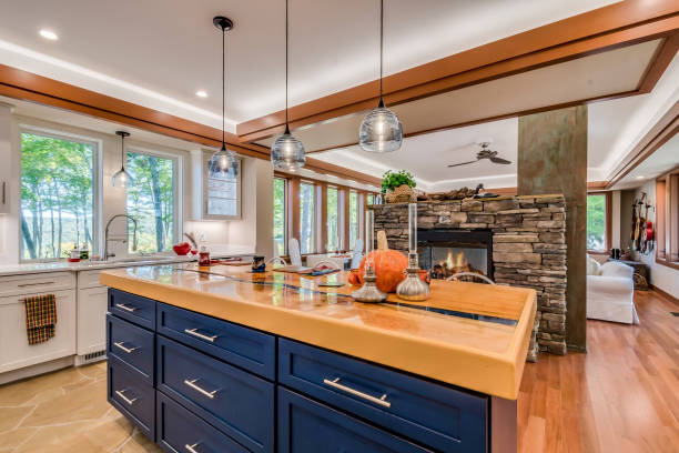 A cozy kitchen featuring a stone fireplace and elegant blue cabinets, creating a warm and inviting atmosphere – perfect for kitchen remodeling in Hillsborough, CA.