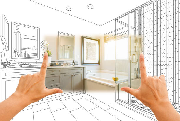 Hands framing a custom master bathroom photo section with a drawing behind, representing luxury bathroom remodeling in Hillsborough.