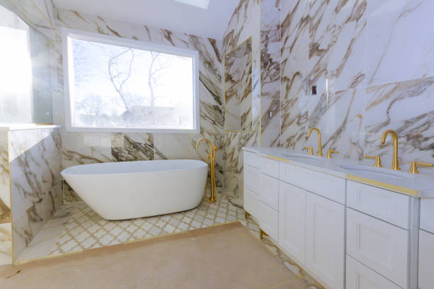 A luxurious bathroom featuring elegant marble walls and a stylish bathtub, showcasing luxury bathroom remodeling in Hillsborough.