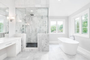 A bright white bathroom featuring a spacious walk-in shower with modern fixtures, showcasing a bathroom remodel in Tiburon, CA