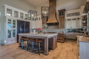 A spacious kitchen remodeling project in Burlingame featuring a central island and elegant wooden flooring.