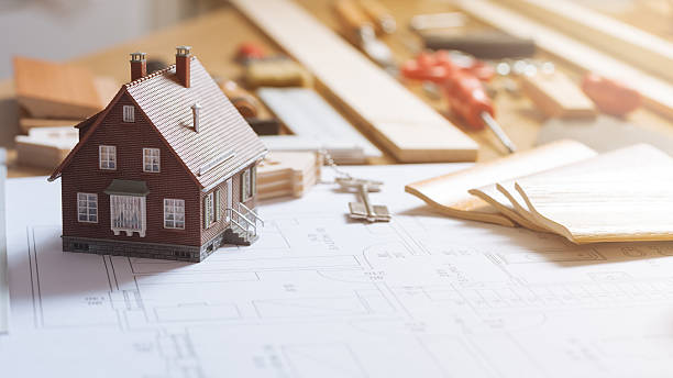 San Francisco home remodel concept with a miniature house and detailed blueprint highlighting architectural design and planning.